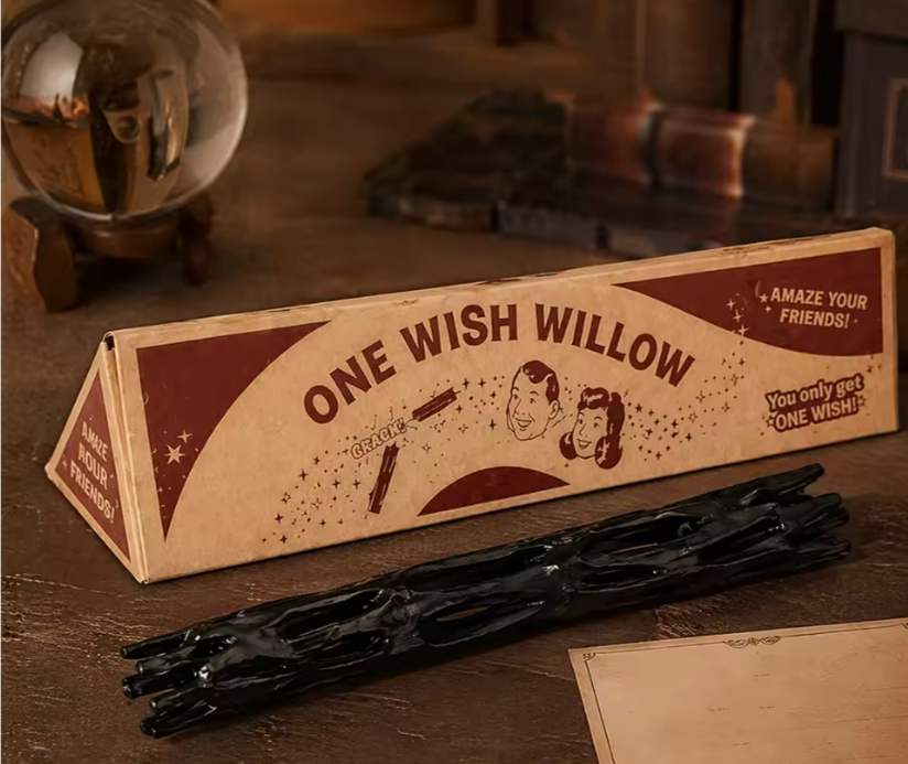 One Wish Willow box and black prop stick on a dark wooden table